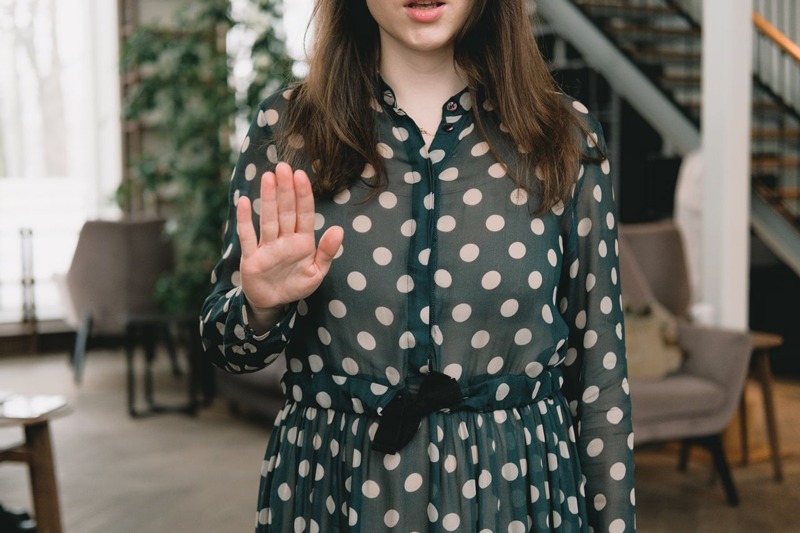 A woman holding up a hand in a stop gesture